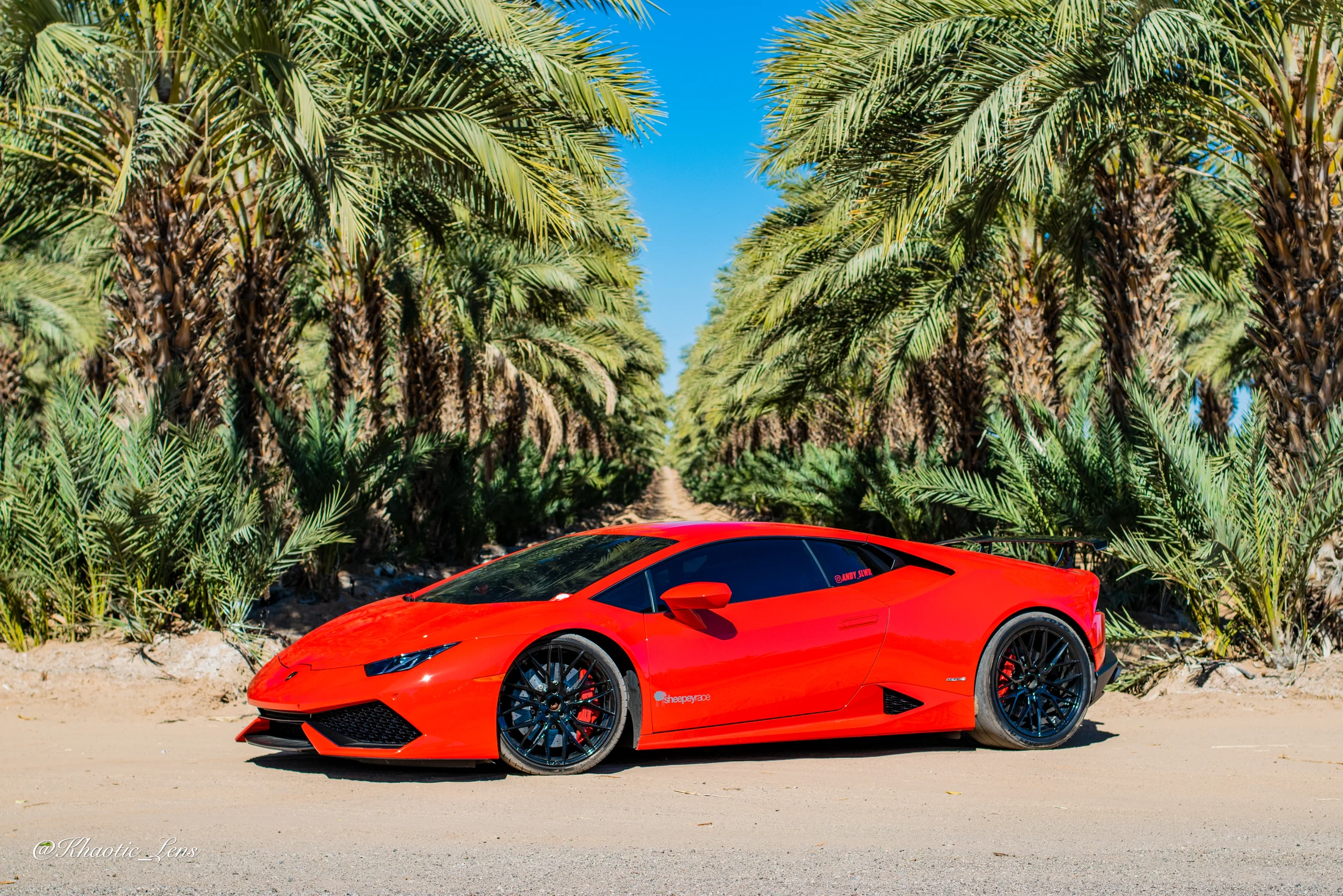Red Lamborghini photographed in a wide automotive composition by Khaotic Lens