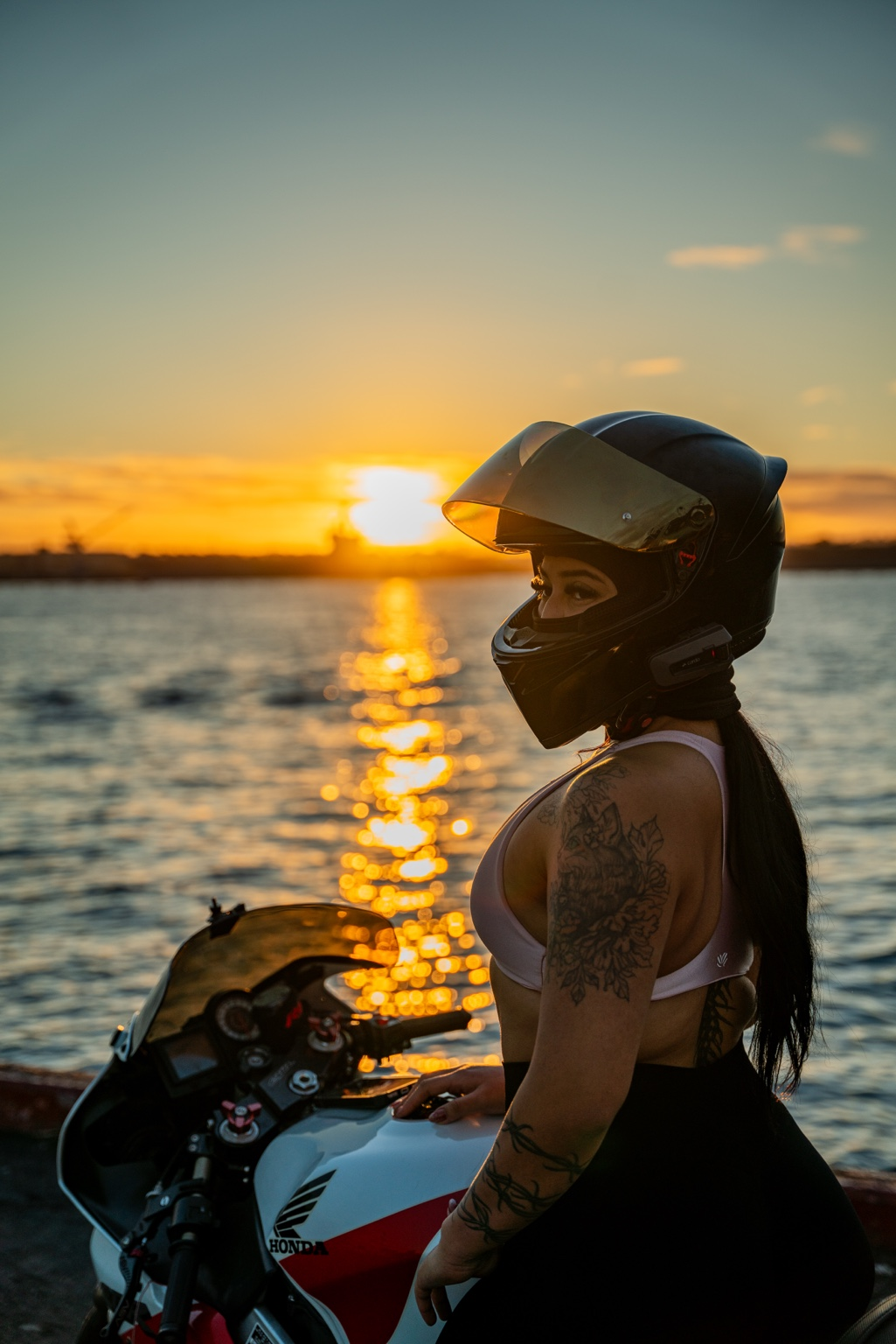 Dalilla posing beside a motorcycle at sunset for Khaotic Lens Photography